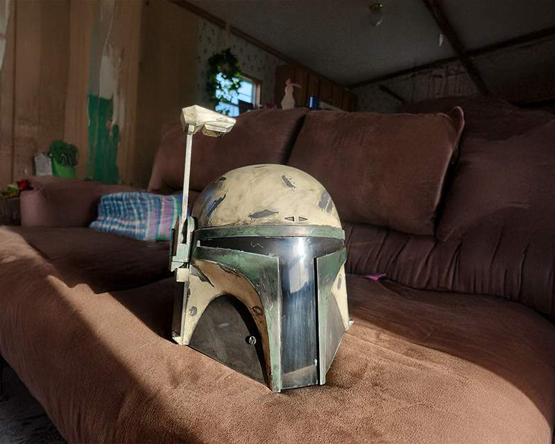 A battered helmet resting on a brown sofa in a dim living room.